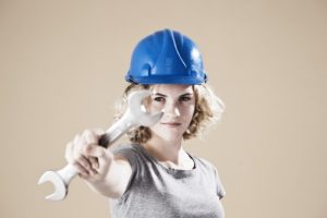 Teenage Girl With Hard Helm And Hand Tool