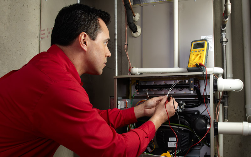 Family Warming Up Hands Over Electric Heater