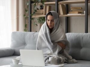 Woman Cold And Paying High Heating Bills