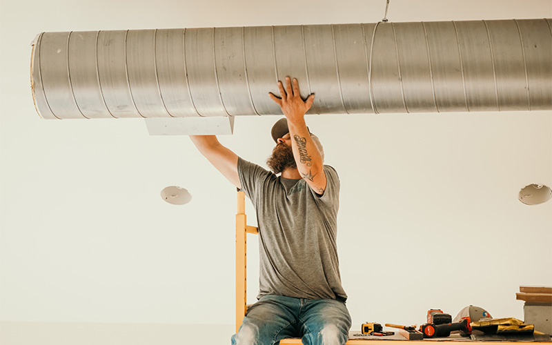 tech working on ductwork
